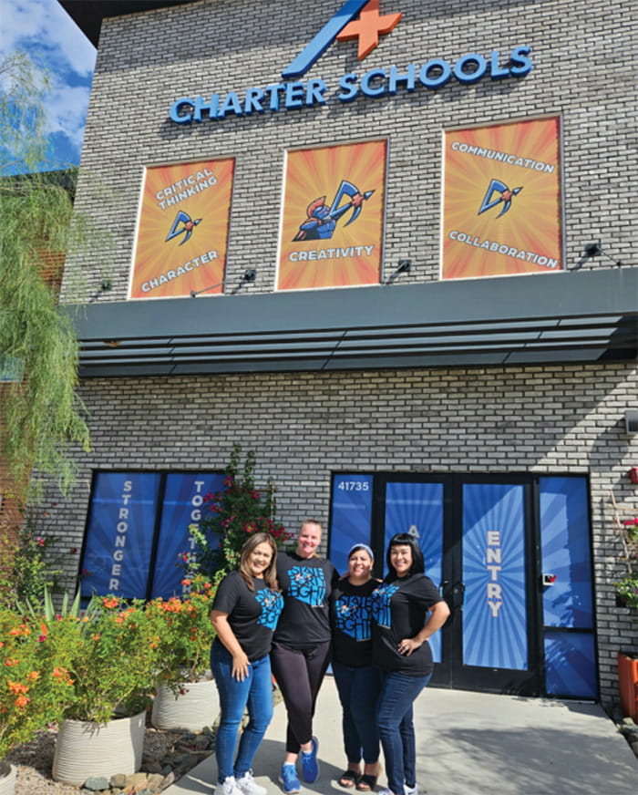 Four ladies in front of A+ Charter Schools building