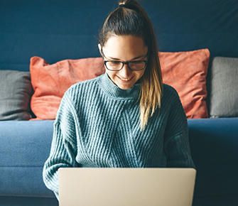 Parent looking at online school calendar from a laptop at home