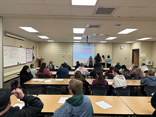 Students in a classroom during a career pathways presentation