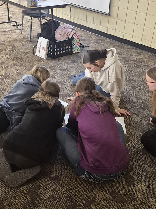 Group of students working together on the floor