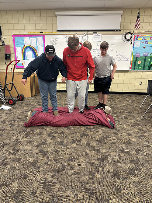 Students rolling up a student during a career pathways experience