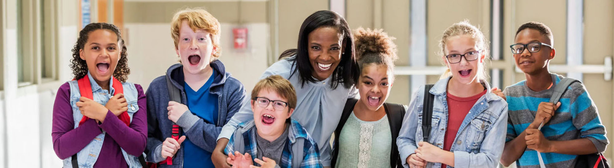 Group of happy elementary students with their teacher