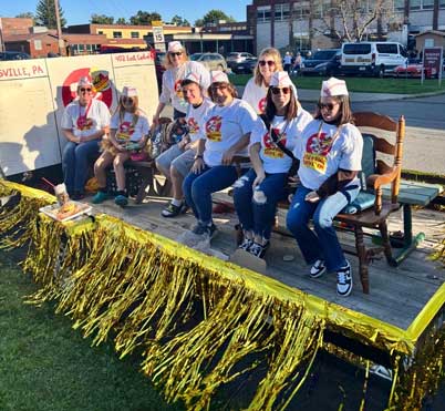 Students and adults on the homecoming float Students on a parade float