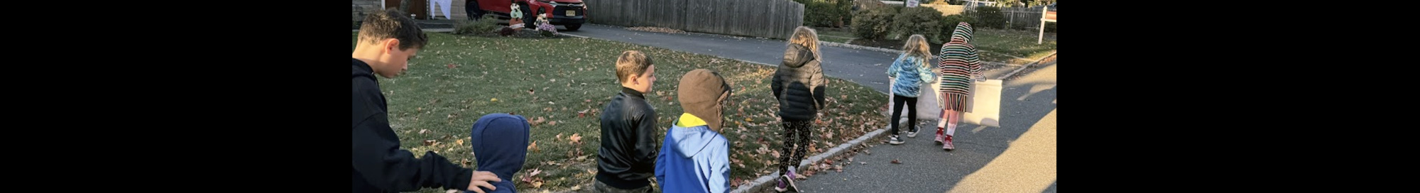 Students and adults walking in a neighborhood