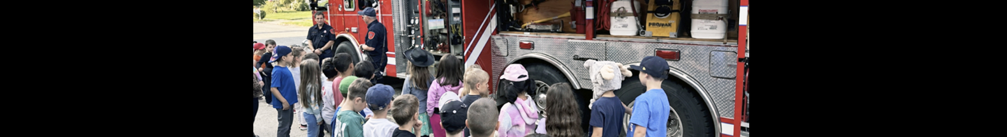 Students outside enjoying a visit from the local fire department