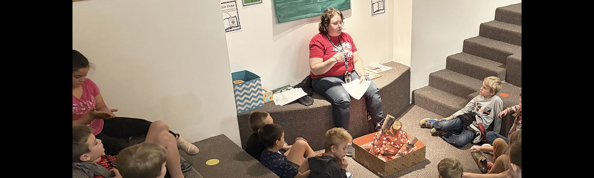 Teacher talking to students in front of a project